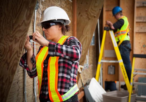 A female Electrical Apprenticeship students working on a construction site